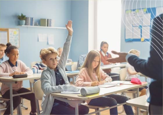 boy raising hand in classroom